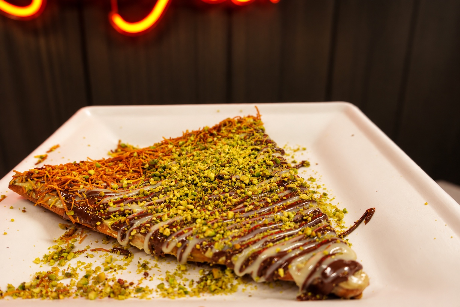 Crepe with pistachios and chocolate drizzle